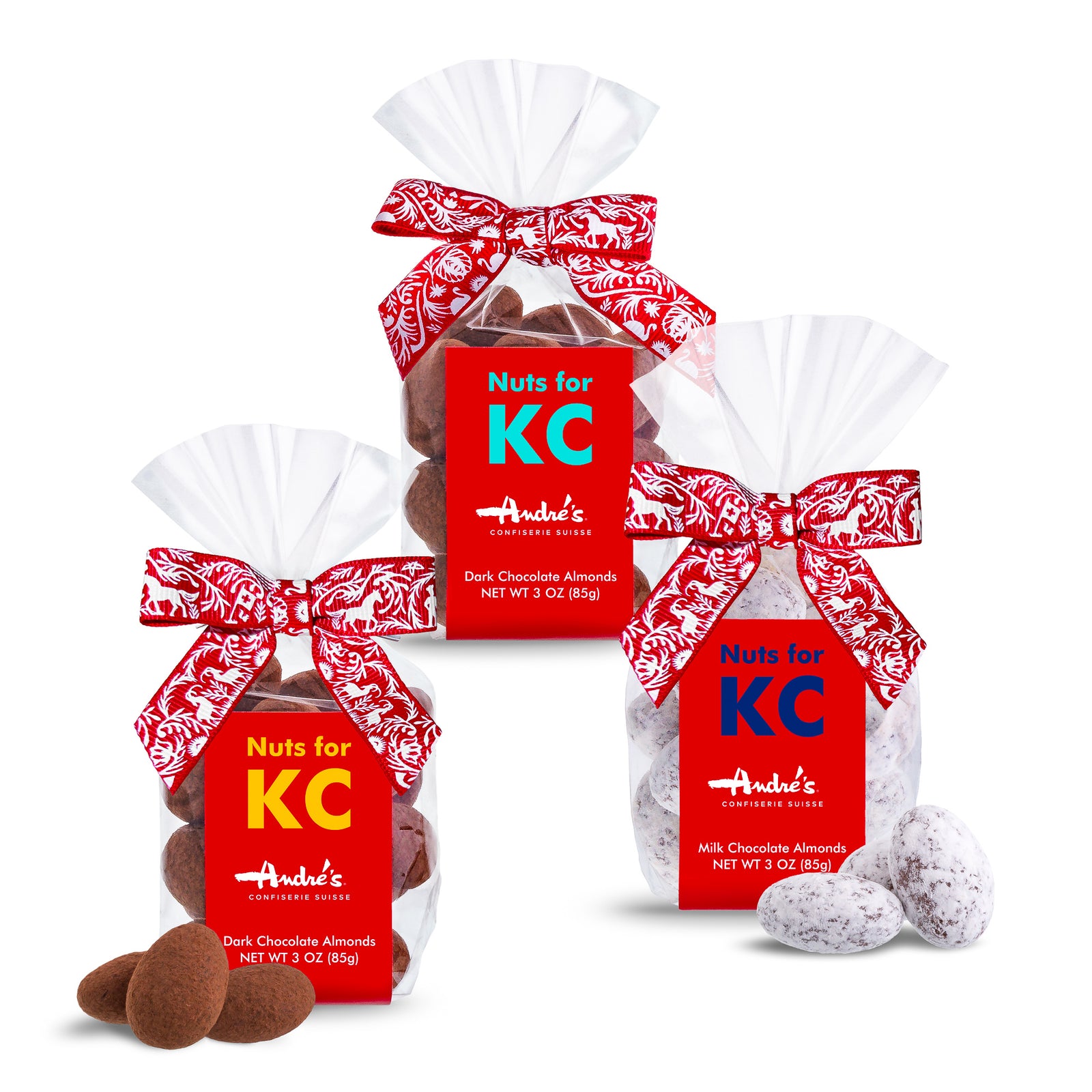 3 clear bags of Chocolate covered almonds with a red & white Swiss print bow and red product label with "Nuts for KC" in dark blue, gold, or teal print