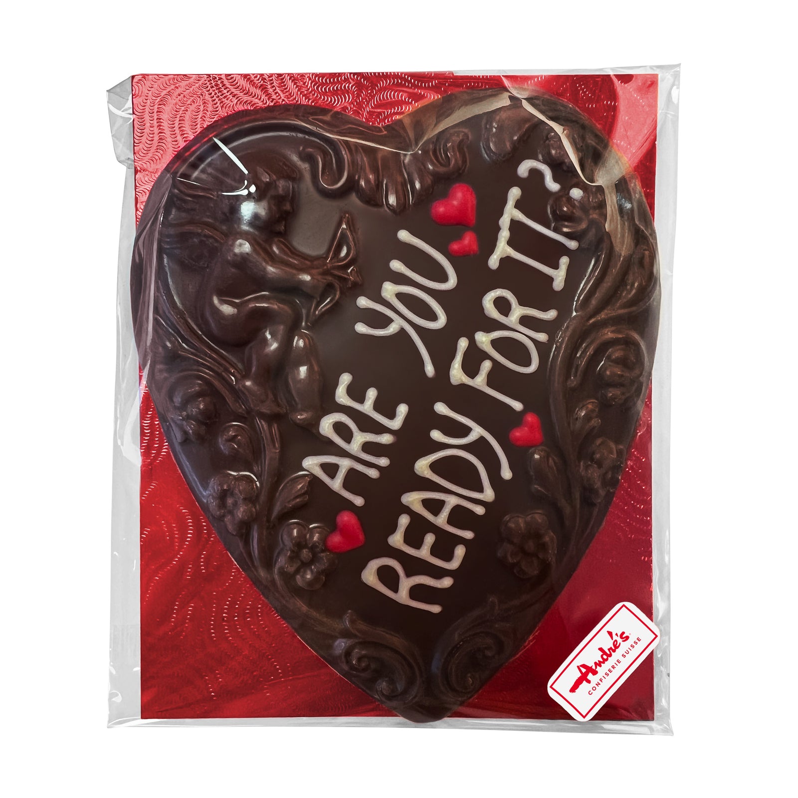 Milk chocolate heart with cupid and scoll design and "I Wanna Be Your End Game" written in white chocolate, sitting on a red base, in a clear bag.