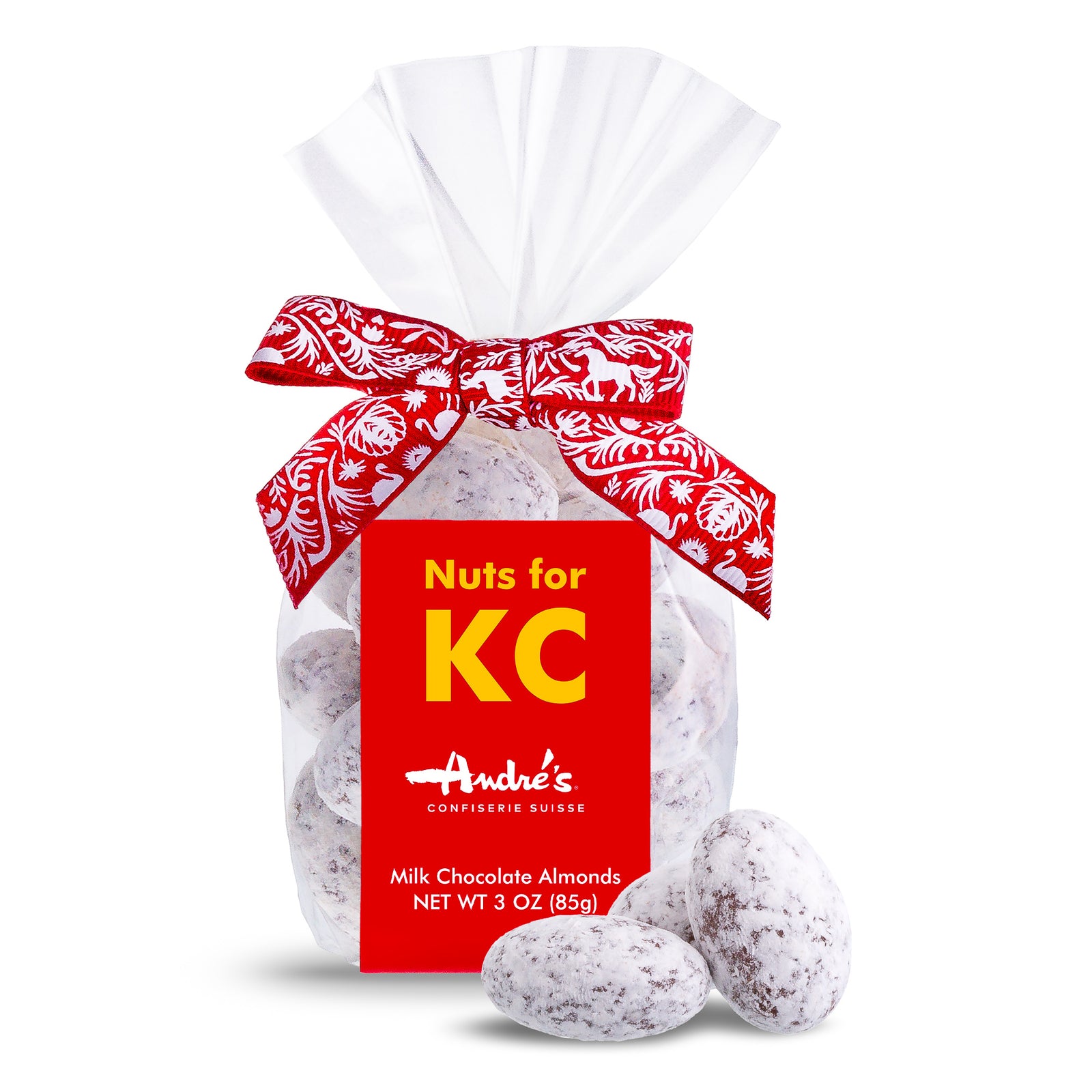 3 clear bags of Chocolate covered almonds with a red & white Swiss print bow and red product label with "Nuts for KC" in dark blue, gold, or teal print