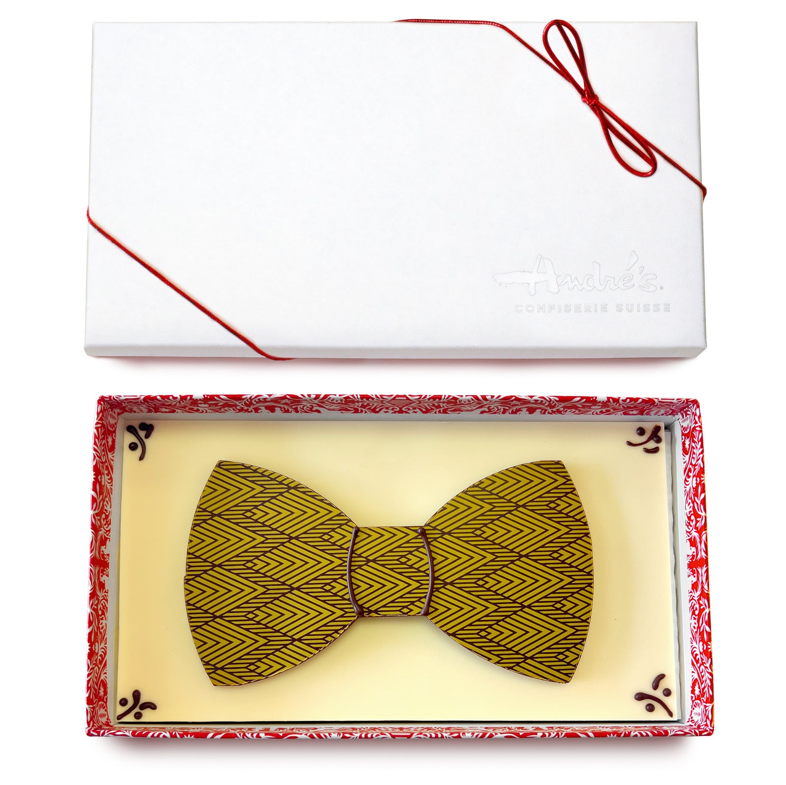 4 brightly colored flat chocolate bow ties on white chocolate bases in boxes without lids.