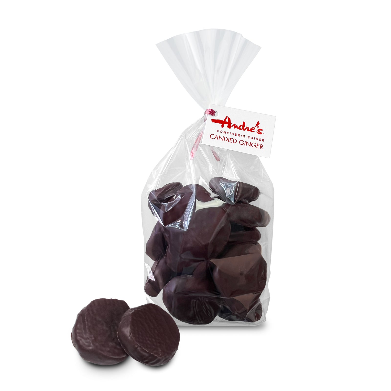 clear bag filled with dark chocolate covered round ginger slices tied with a red & white product tag, and 2 loose candies beside