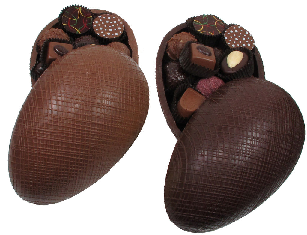 dark chocolate egg with multicolor design, open with assorted candies visible inside.