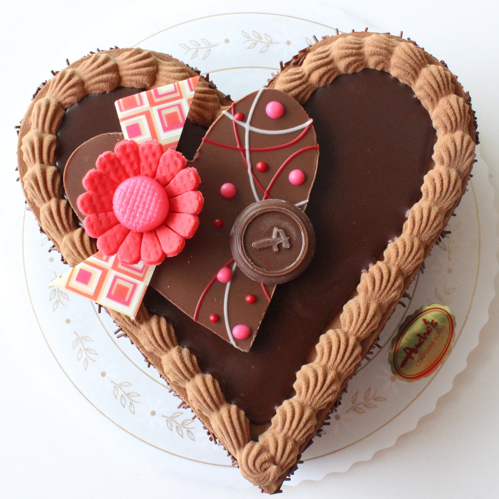 Heart shaped torte with chocolate ganache top and chocolate heart decor. 