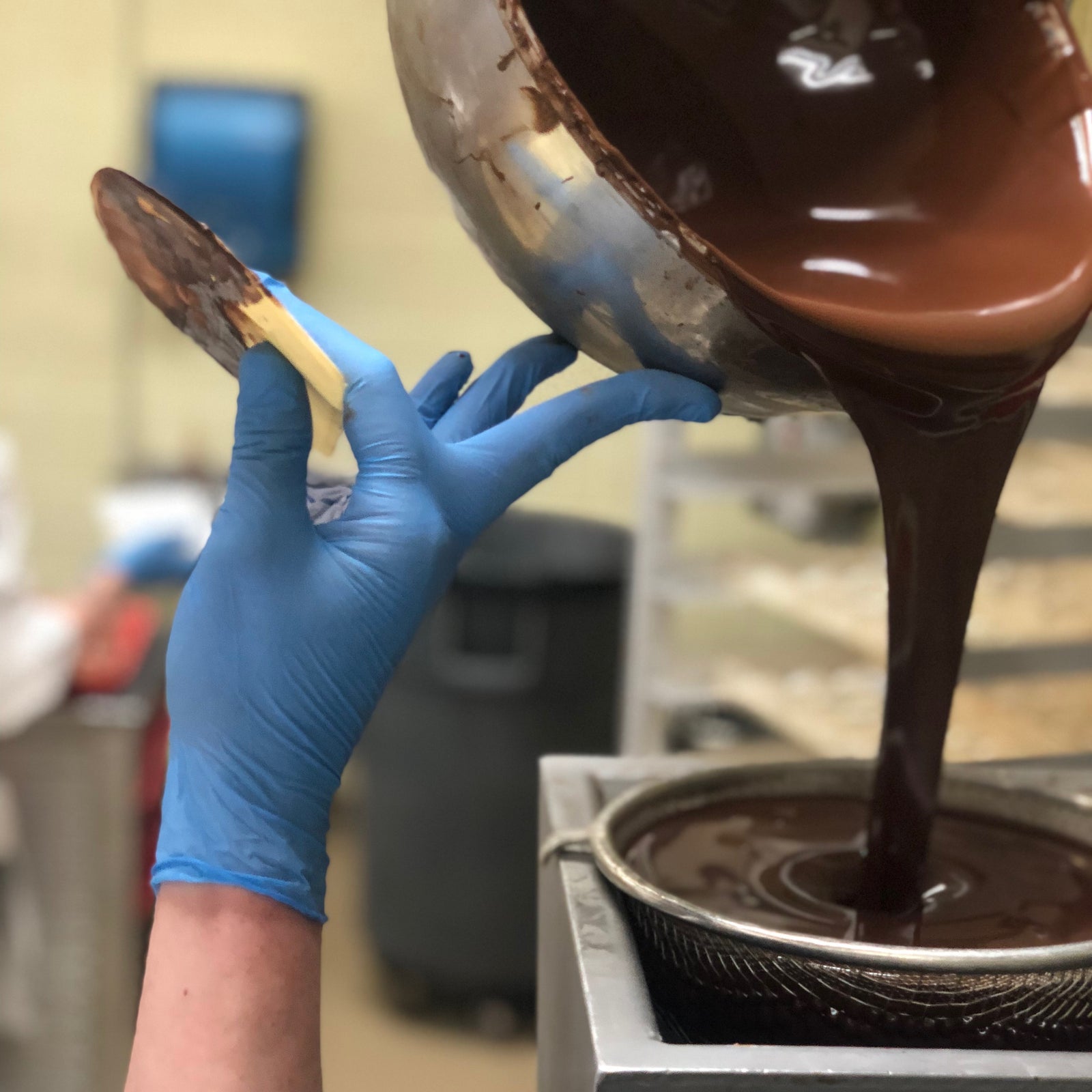 Chocolate being poured through a strainer.