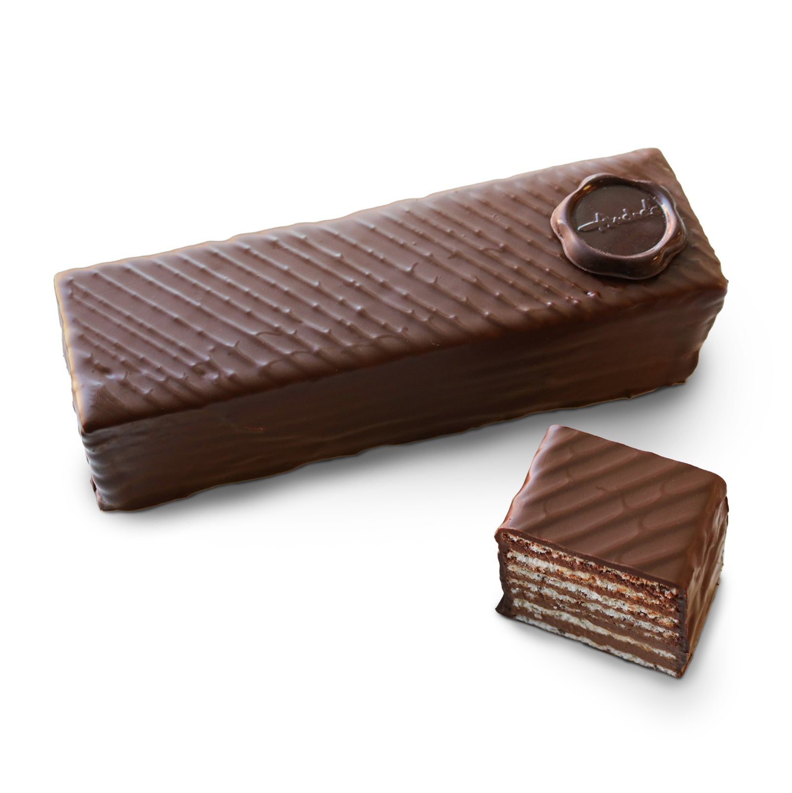 Chocolate covered rectangle cake, topped with a stripe design and Andre's logo chocolate medallion, with a slice beside. Layers of cake and chocolate are visible inside.