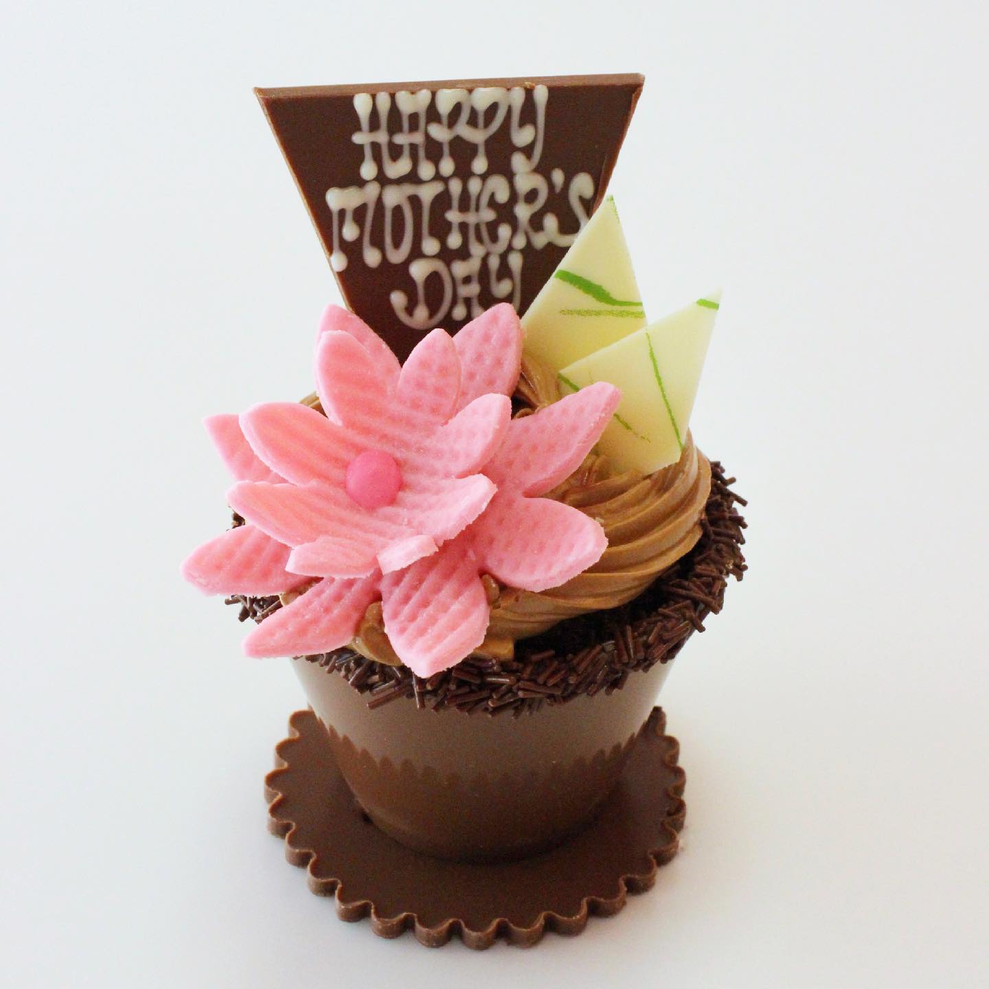a chocolate flowerpot topped with a swirl of buttercream, pink marzipan flower, and chocolate spears, one with "Happy Mother's Day" printed on it.
