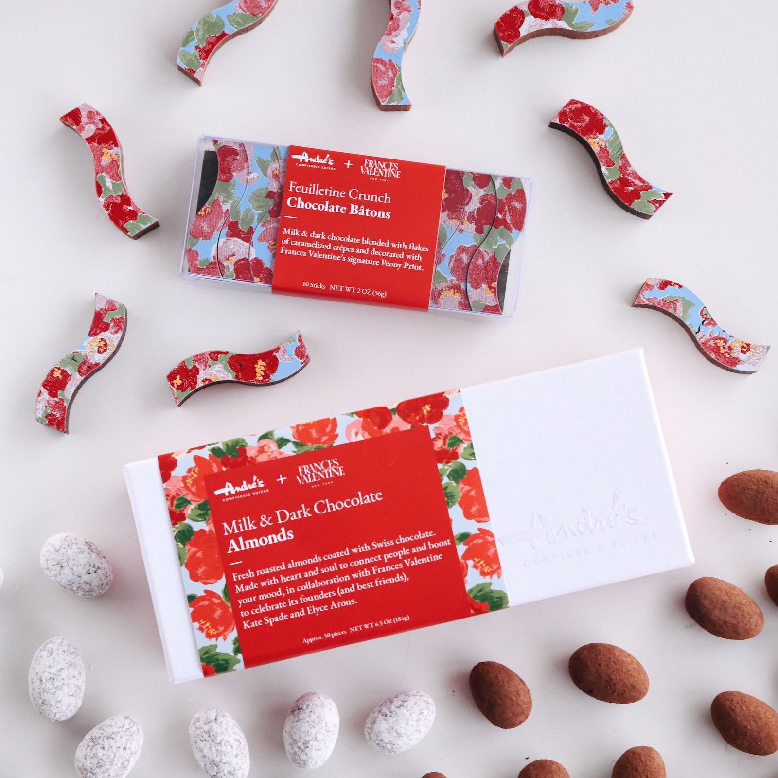 open box of milk and dark chocolate almonds with the white lid and signature Frances Valentine floral wrapper beside