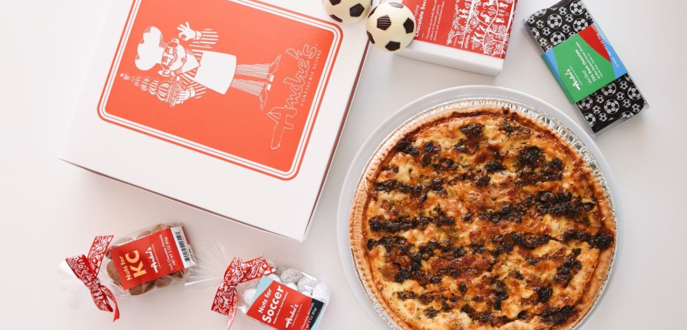 Quiche on a white surface with decorative boxes and candies around it