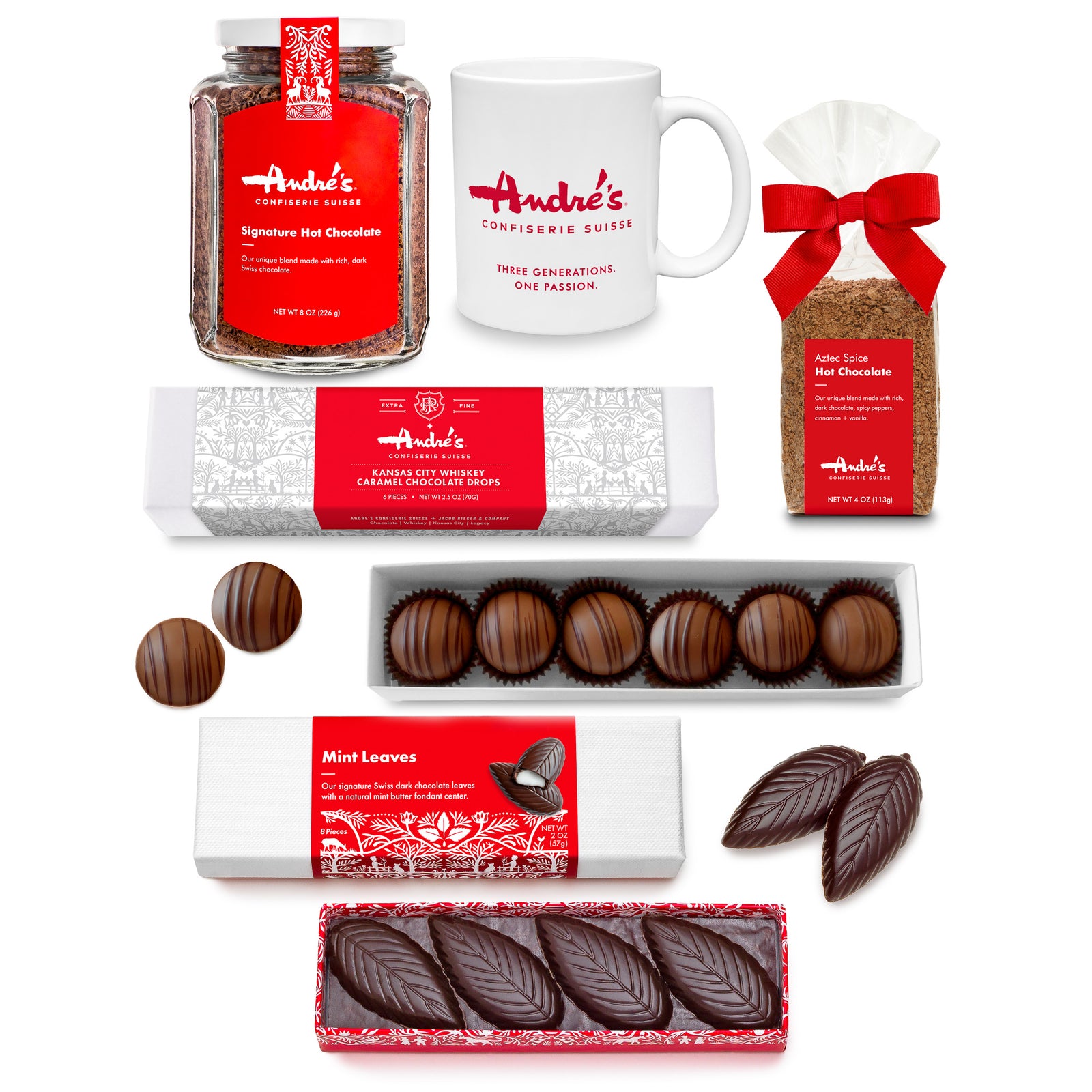 collection photo of the individually packaged contents of the Hot Chocolate Bundle: Hot Chocolate jar, mug, hot chocolate bag, whiskey caramel drops box, mint leaves box. All with red & white Swiss print packaging.