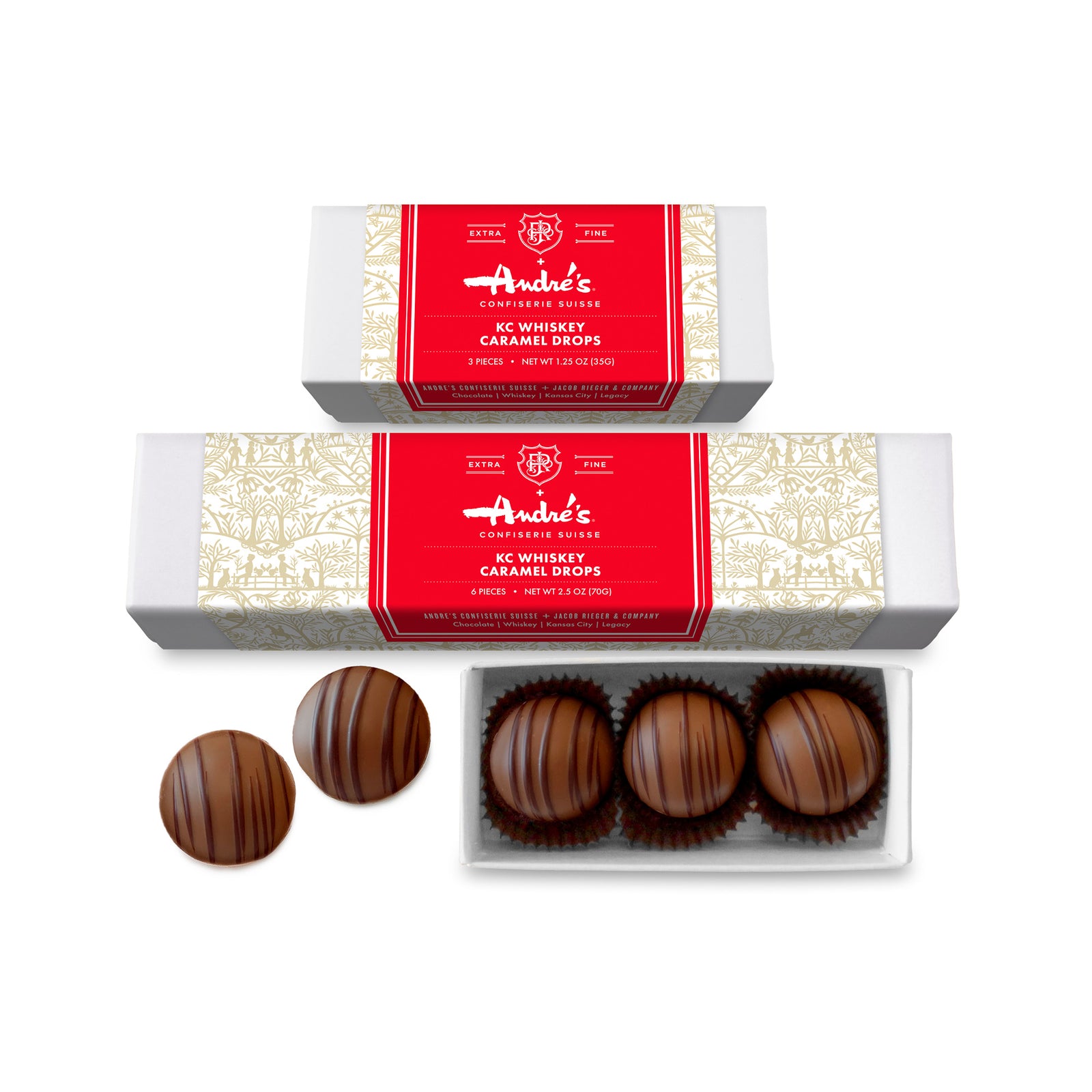 Long box with 6 round milk chocolate candies inside, 2 loose candies, and 2 closed boxes with red, white and gold product information labels