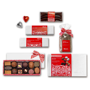 Overhead view of the items in the large gift box arranged on a table. All of them have signature Swiss red and white packaging.