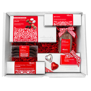 A white cardboard box with red springfill containing the items featured in the large gift box. All of them have signature Swiss red and white packaging.