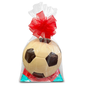 Soccer ball-shaped almond-filled chocolate in a clear bag with a red bow on a white background