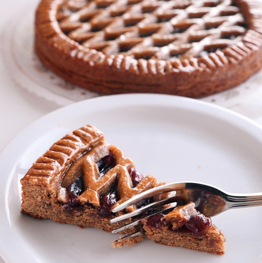 Slice of Linzer with fork cutting a bite.