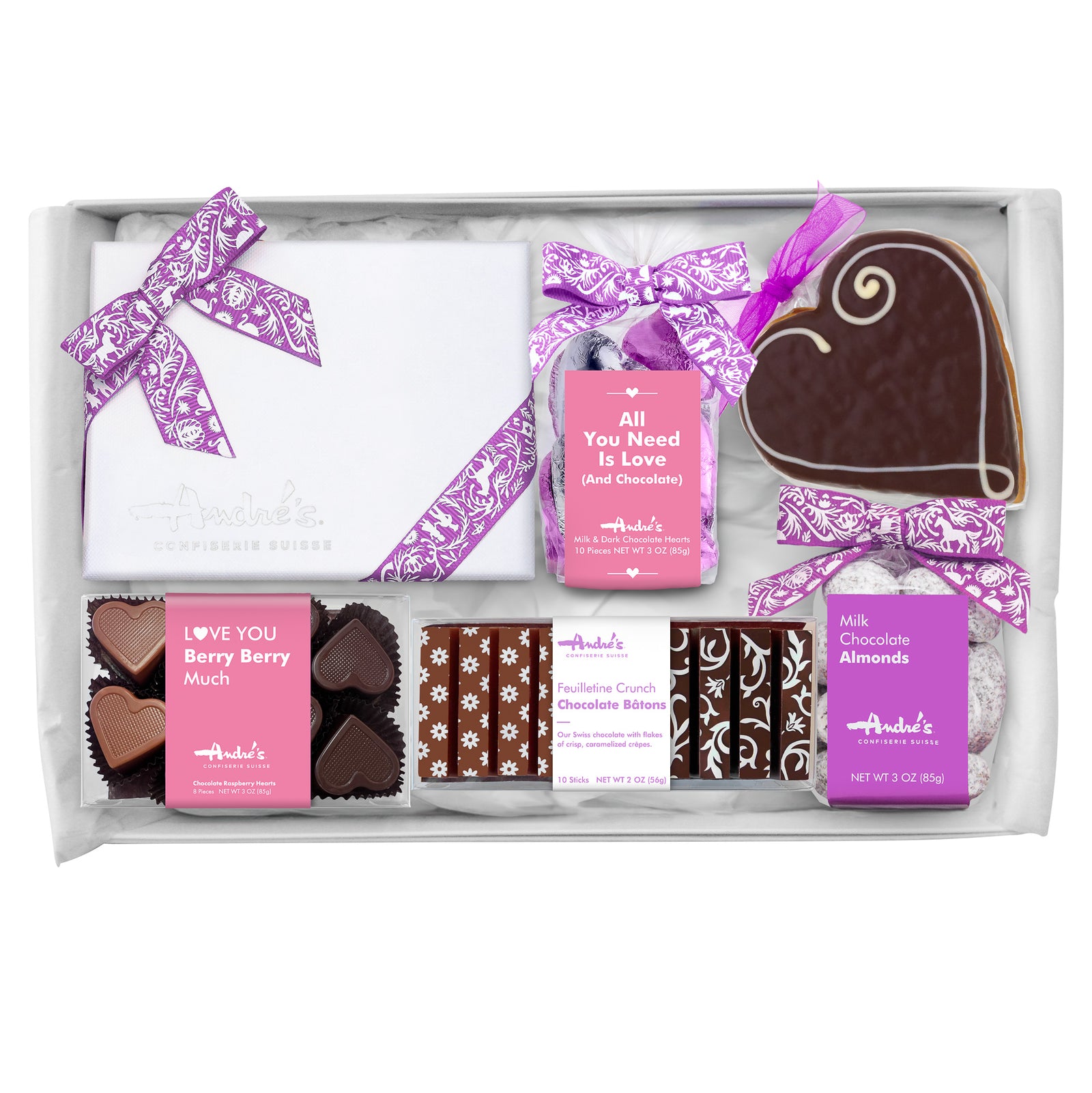 Overhead view of contents of Mother's Day Gift Box, all with purple and pink bows and labels on a white table