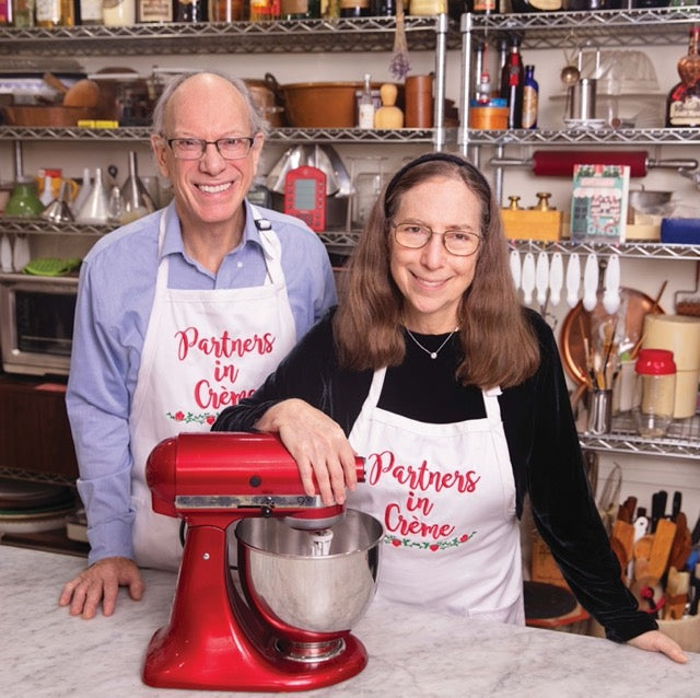 Woody and Rose Levy Berenbaum in kitchen with red stand mixer