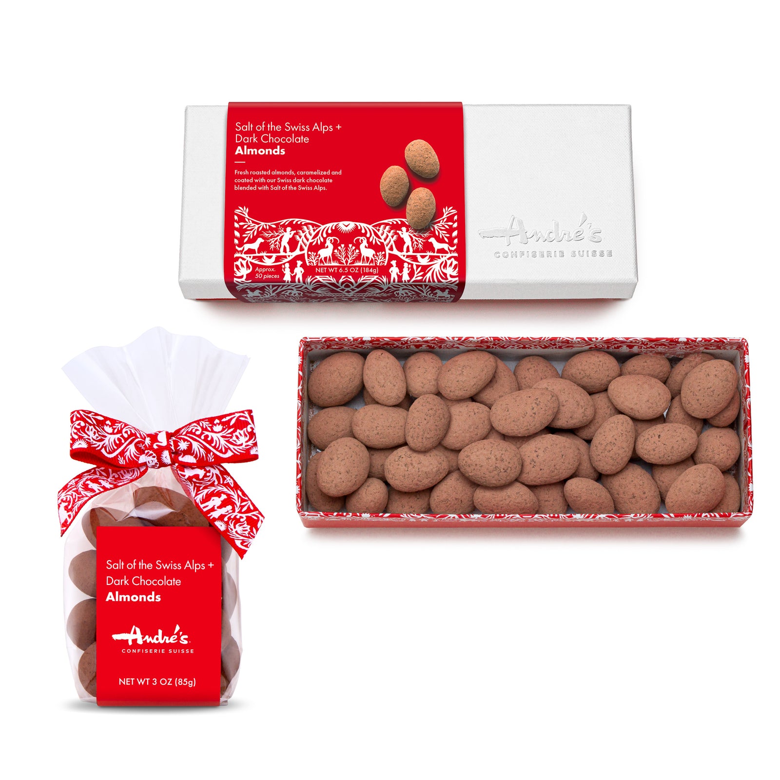 White lid box with red and white wrapper for Salt of the Swiss Alps Chocolate Almonds beside an open box of them and a small clear bag of them with red and white label.