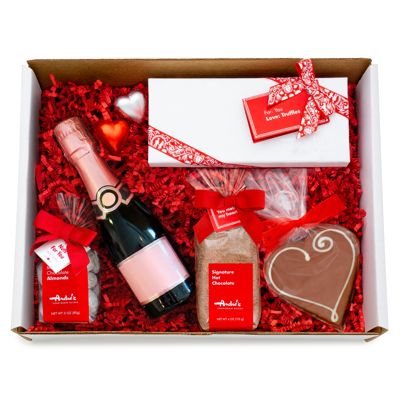 Overhead view of box with red wine bottle and chocolate treats all packed with red springfill