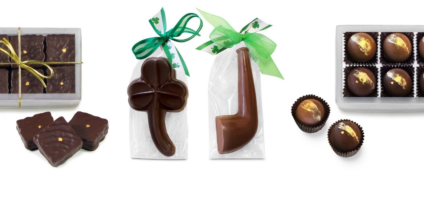 Product variety photo featuring boxed and loose black gold candies, bagged chocolate shamrock and pipe, and boxed Irish cream truffles and caramels.