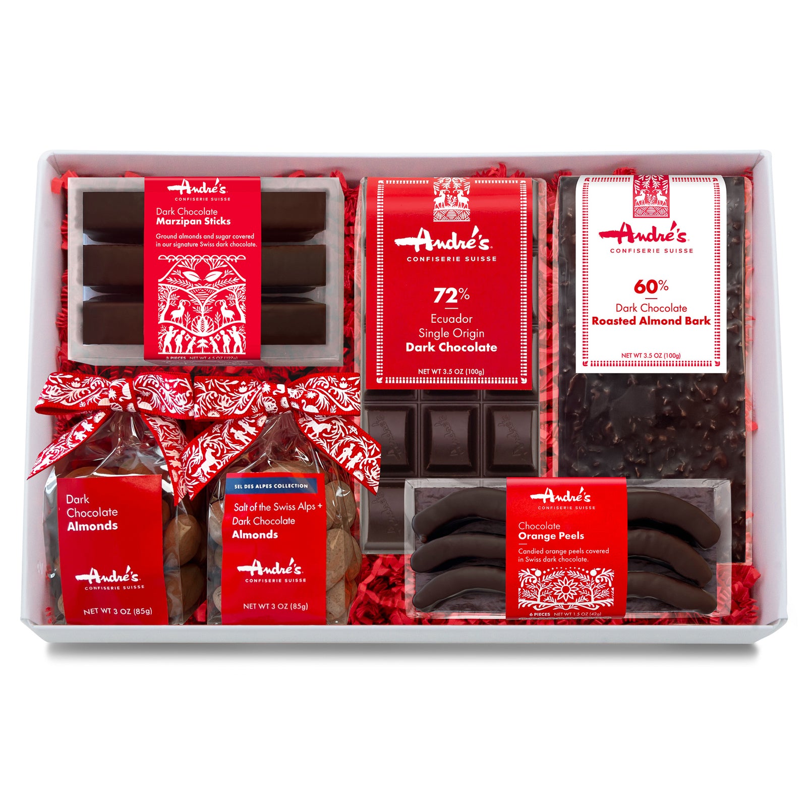 variety shot of the packaged contents of the vegan gift box: dark chocolate marzipan sticks, chocolate orange peels, 72% dark chocolate bar, 60% dark chocolate almond bark bar, dark and salted dark chocolate almonds