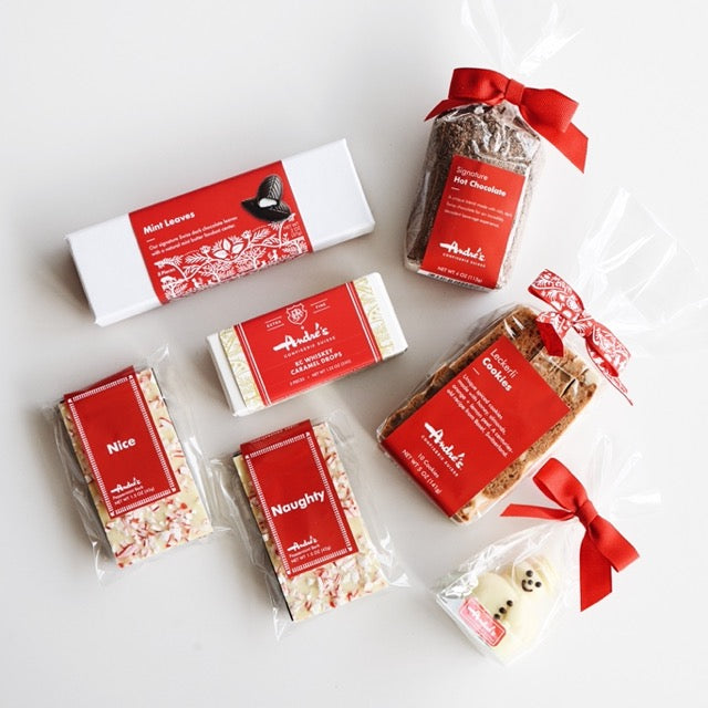 A white box with red springfill containing the items featured in the Winter Holiday Gift Box. All of them have signature Swiss red and white packaging.