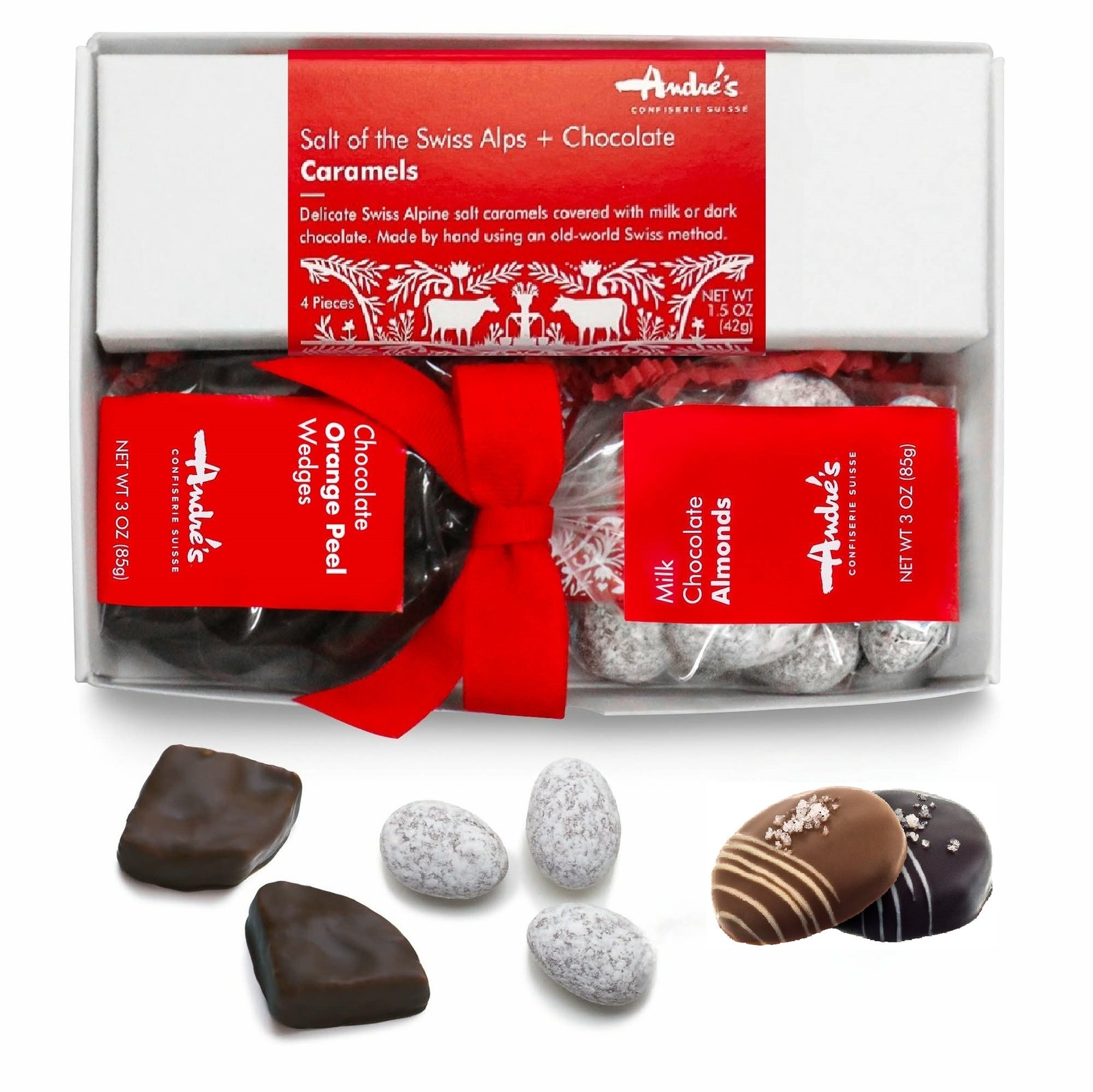 Collection of items for gift box next to a closed box with red ribbon and congrats hang tag.