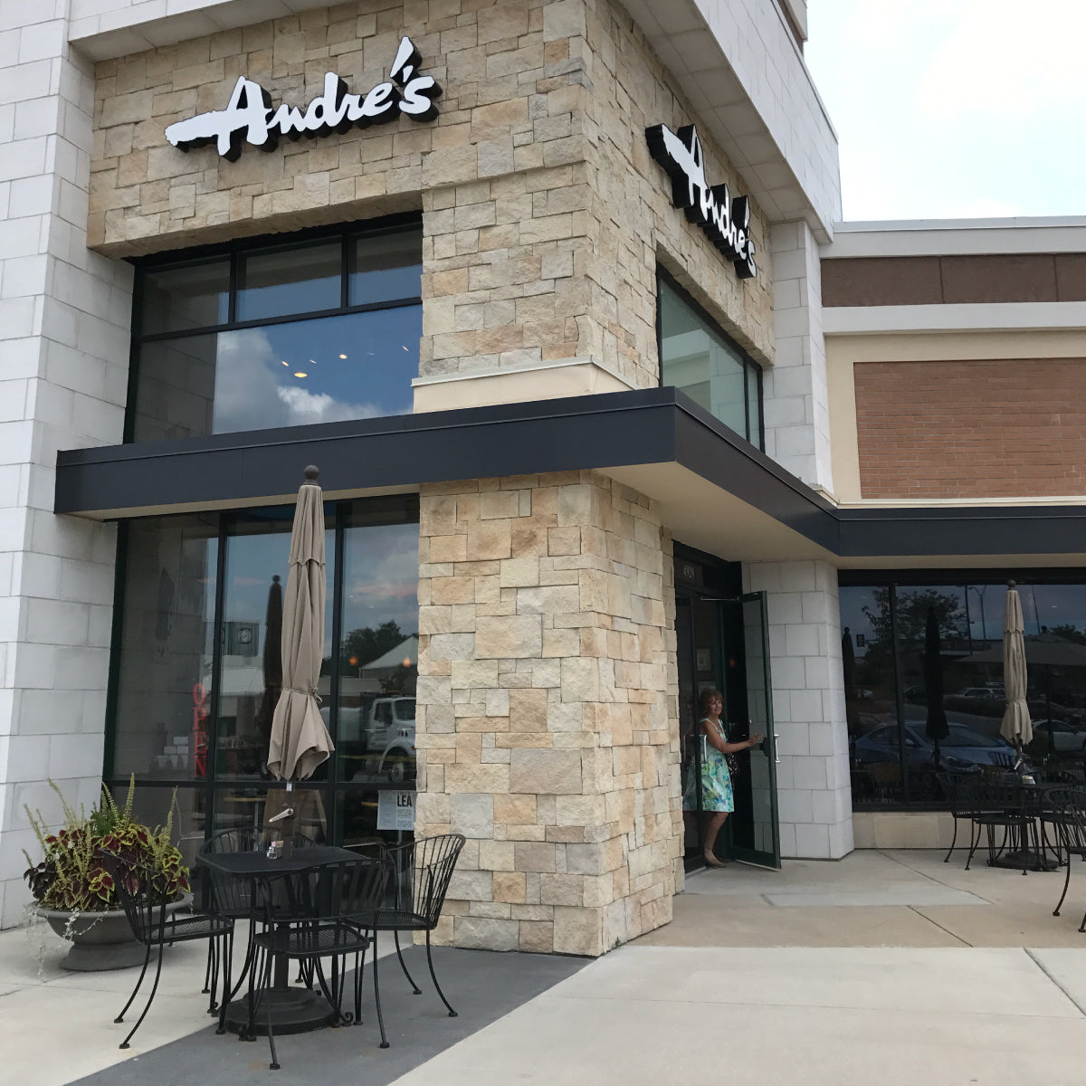 Exterior of the Overland Park Andre's location with patio tables.