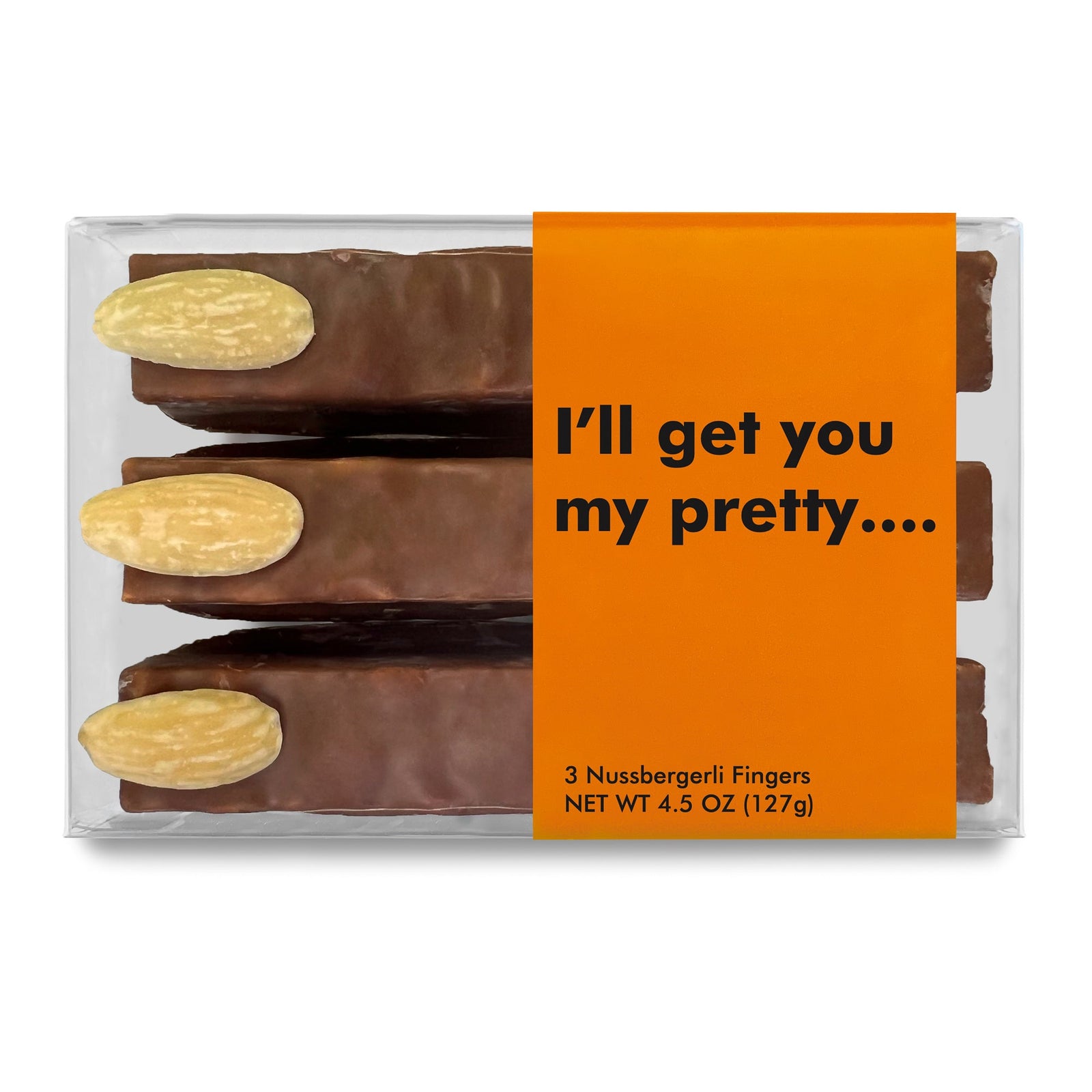 A clear box with 3 chocolate sticks that look like fingers that have almond fingernail with an orange product label that reads "I'll get you my pretty..."