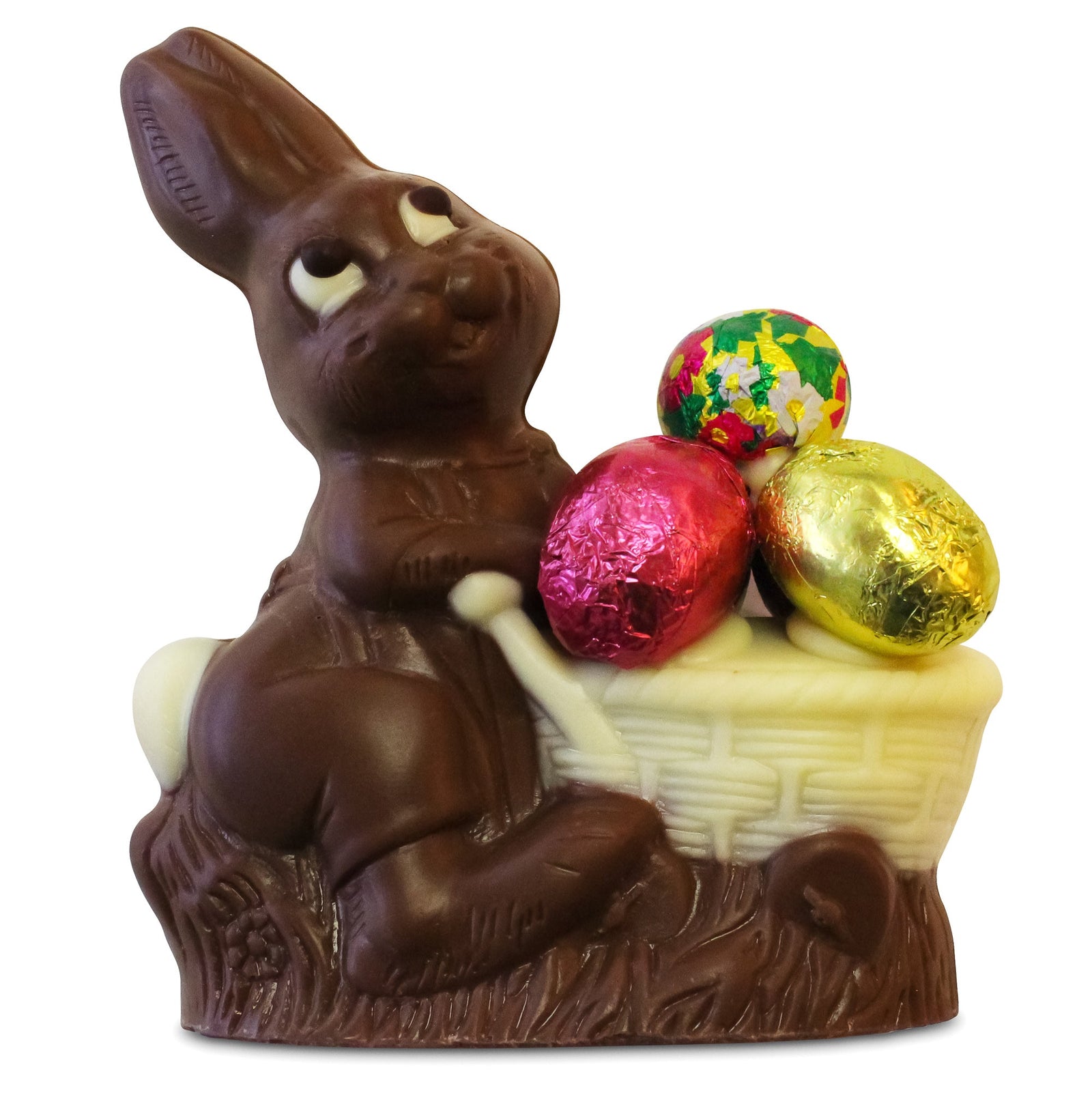 Dark chocolate molded into a smiling bunny that is pushing a white chocolate cart filled with 3 bright colored foil wrapped eggs.
