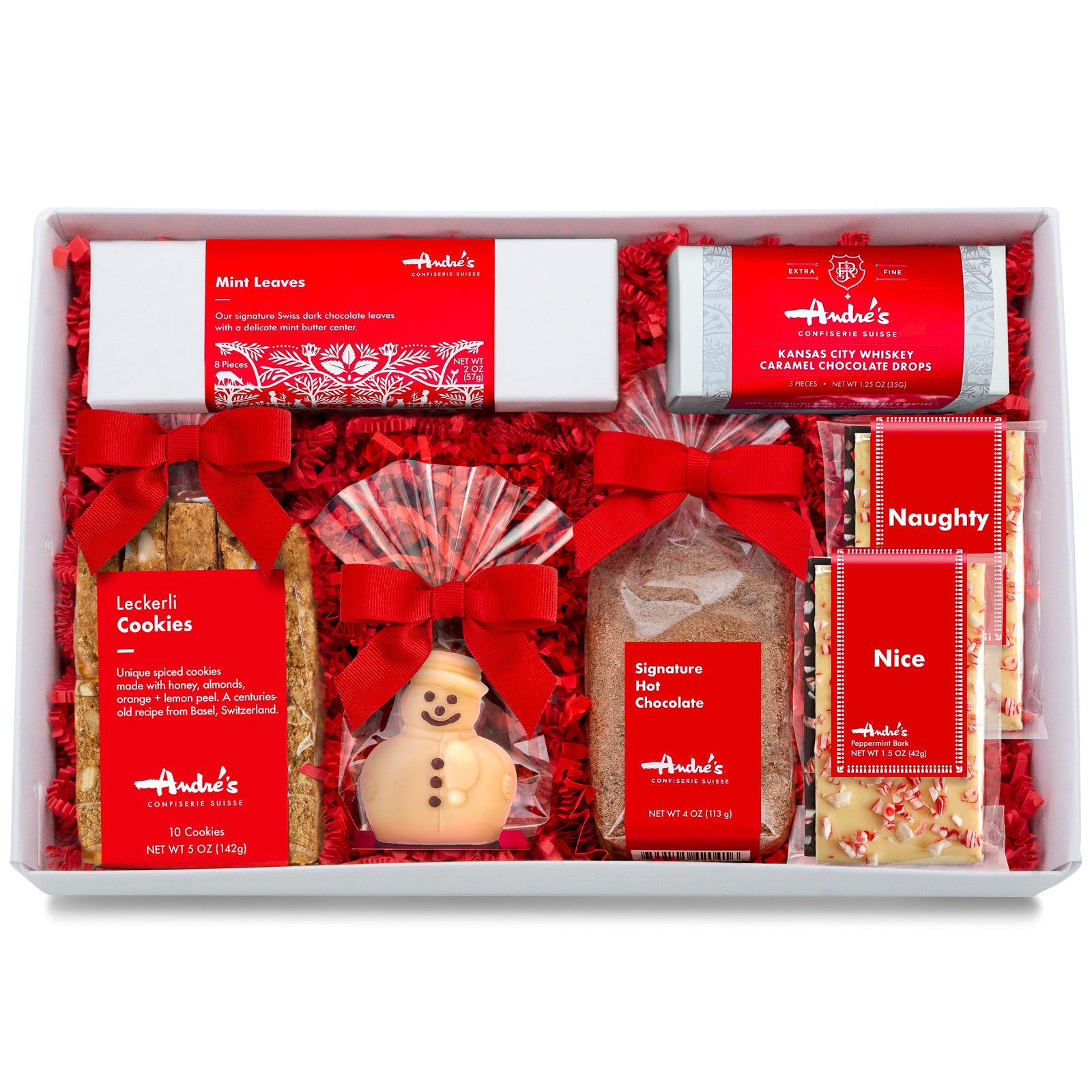 A white box with red springfill containing the items featured in the Winter Holiday Gift Box. All of them have signature Swiss red and white packaging.