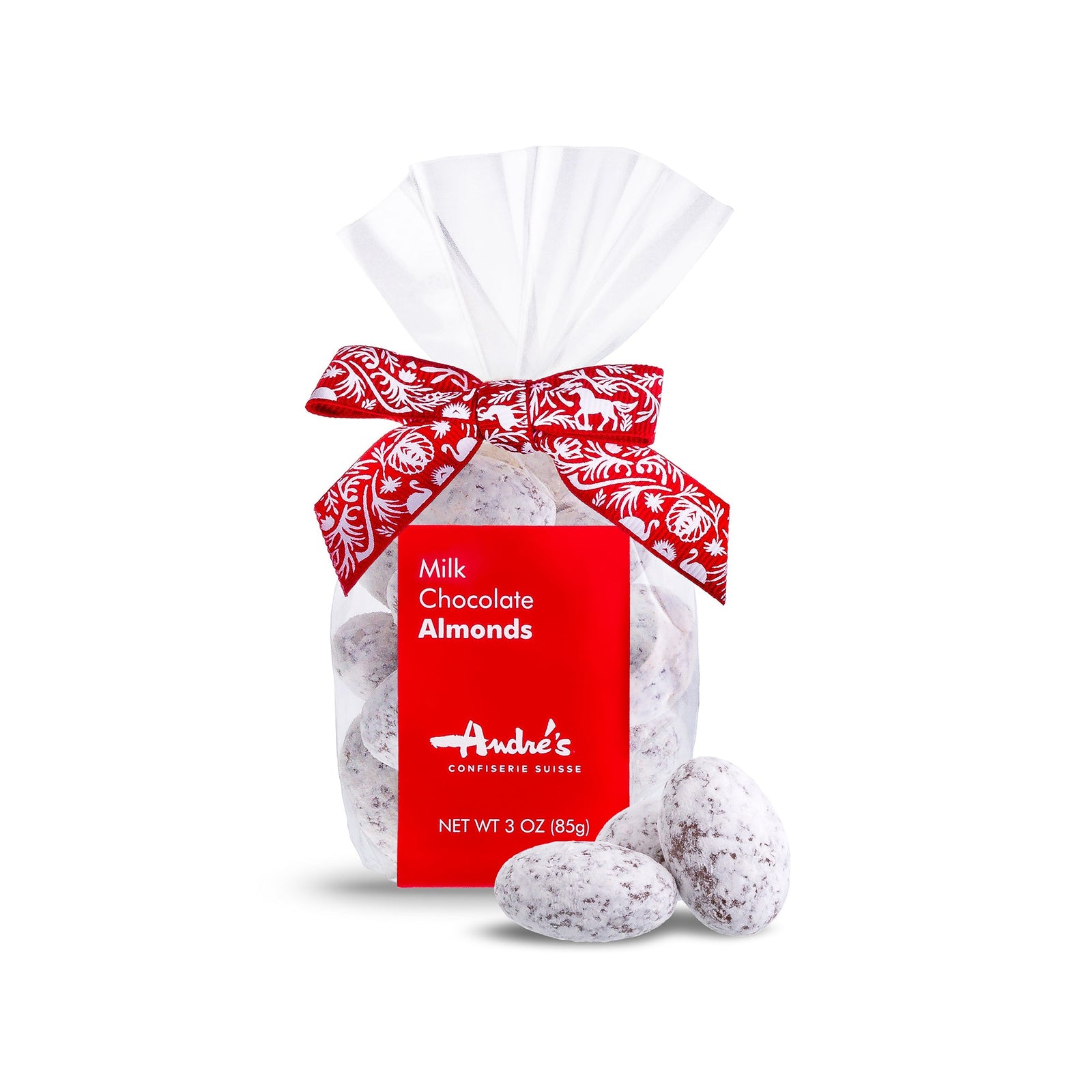 Powdered sugar coated chocolate almonds in a clear bag with red and white Swiss patterned ribbon and red product label.