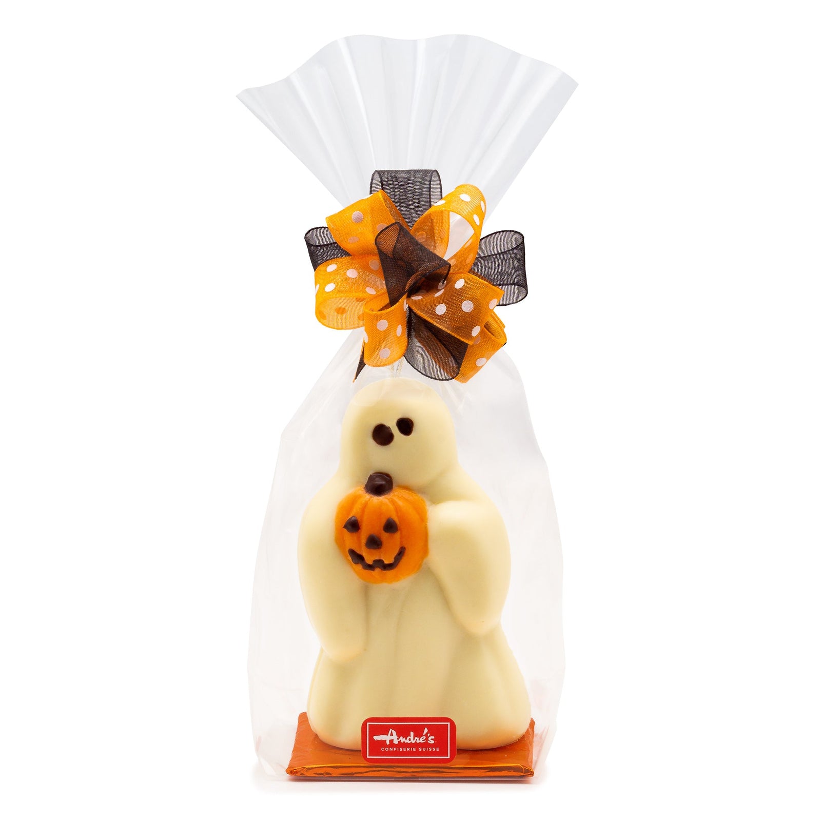 Clear cello bag tied with black and orange-white polkadot ribbon that has a white chocolate ghost inside. The ghost is holding a small orange and black jack o'lantern. 