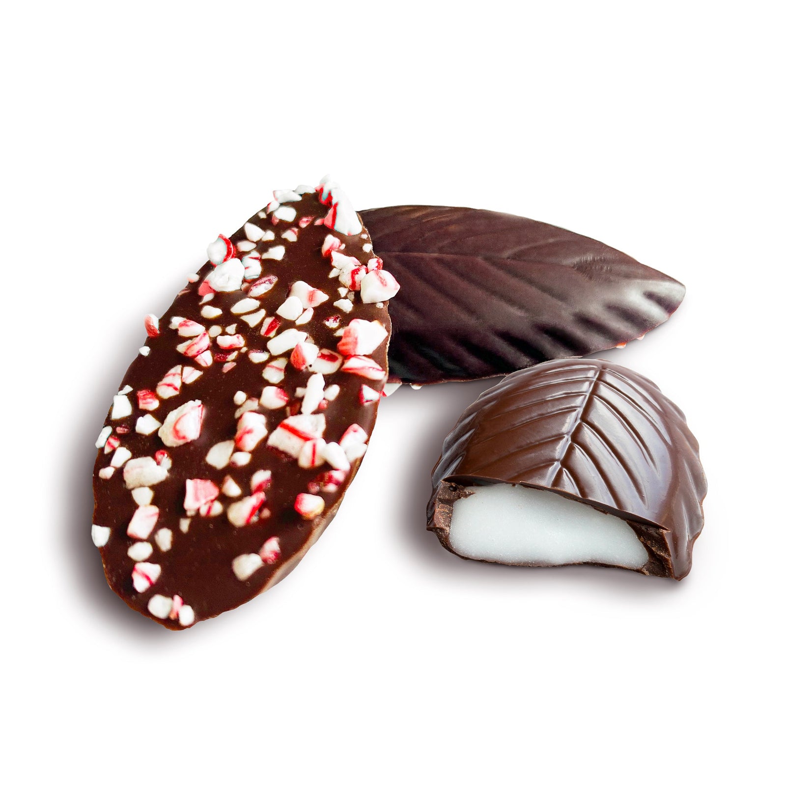 A long white box filled with chocolates that are shaped like mint leaves - every other one upside down to reveal crushed bits of peppermint candy. 