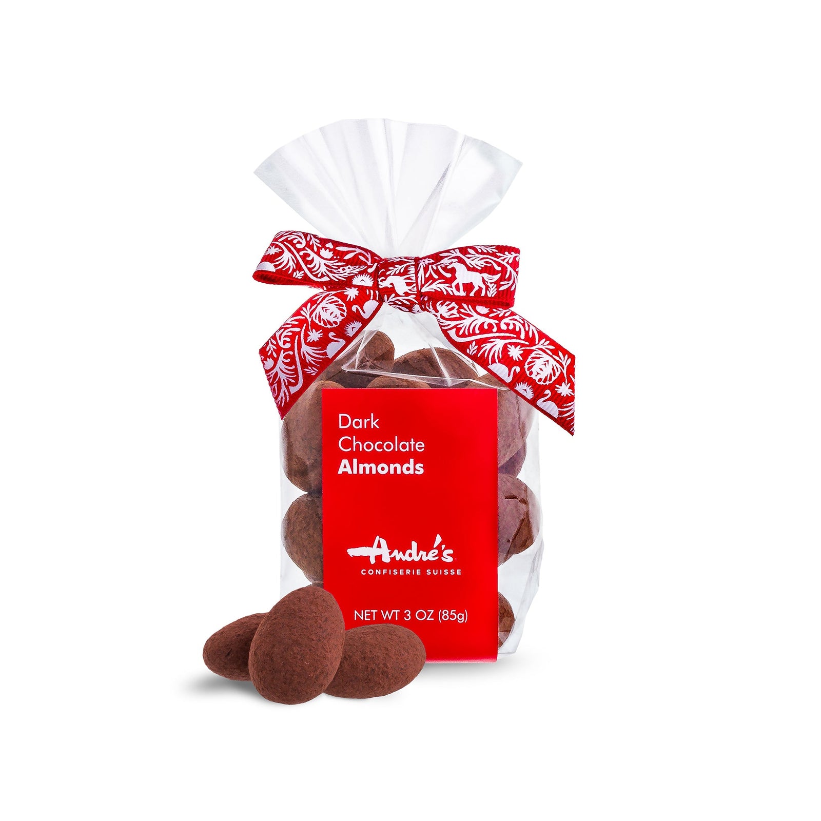 Cocoa powder coated chocolate almonds in a clear bag with red and white Swiss patterned ribbon and red product label.