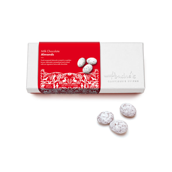 White logo box with red Swiss print product label next to a cluster of powdered sugar covered chocolate almonds.