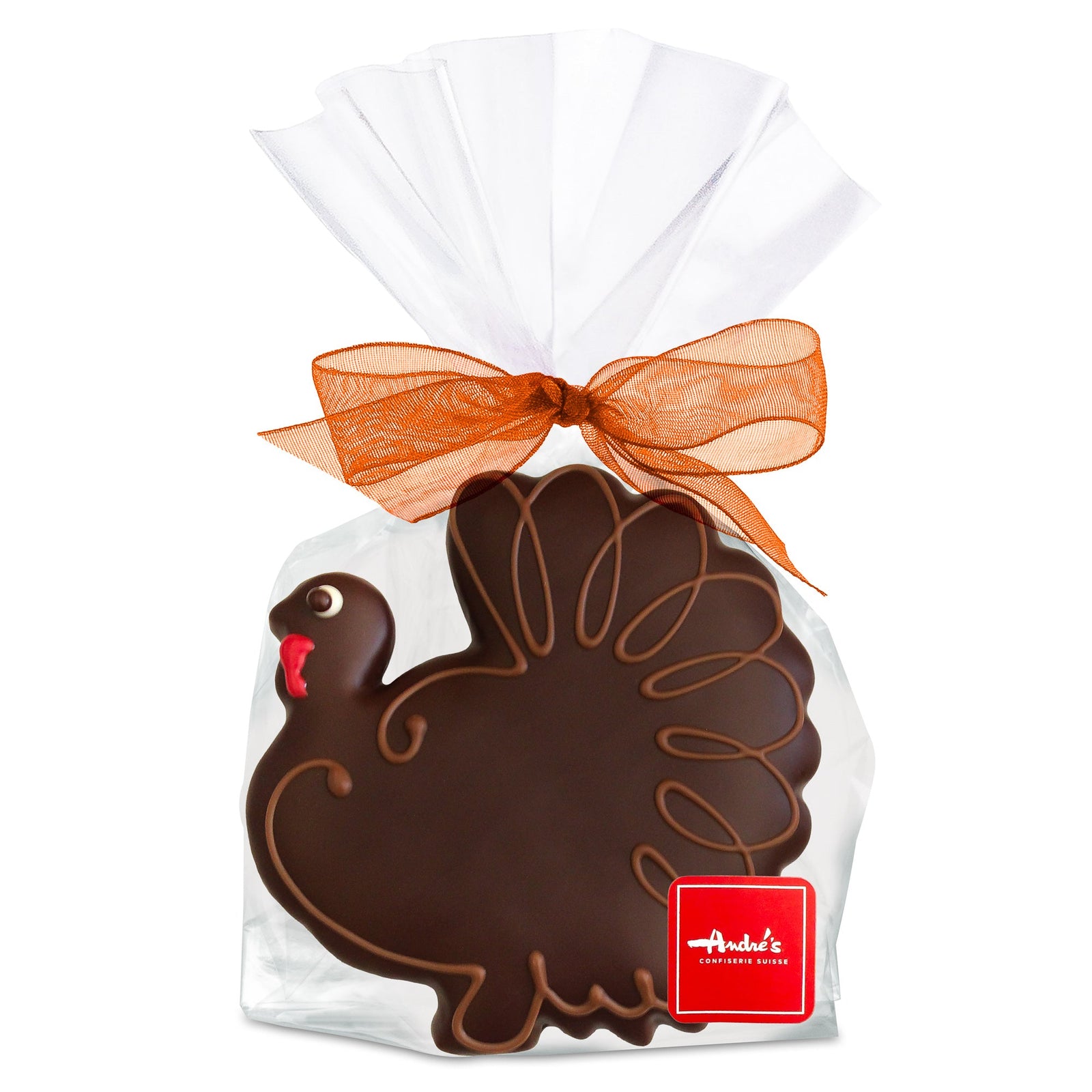 Turkey shaped cookie, covered with dark chocolate and iced to show eye, waddle, and shape of feathers, in a clear bag with orange bow and red logo sticker.