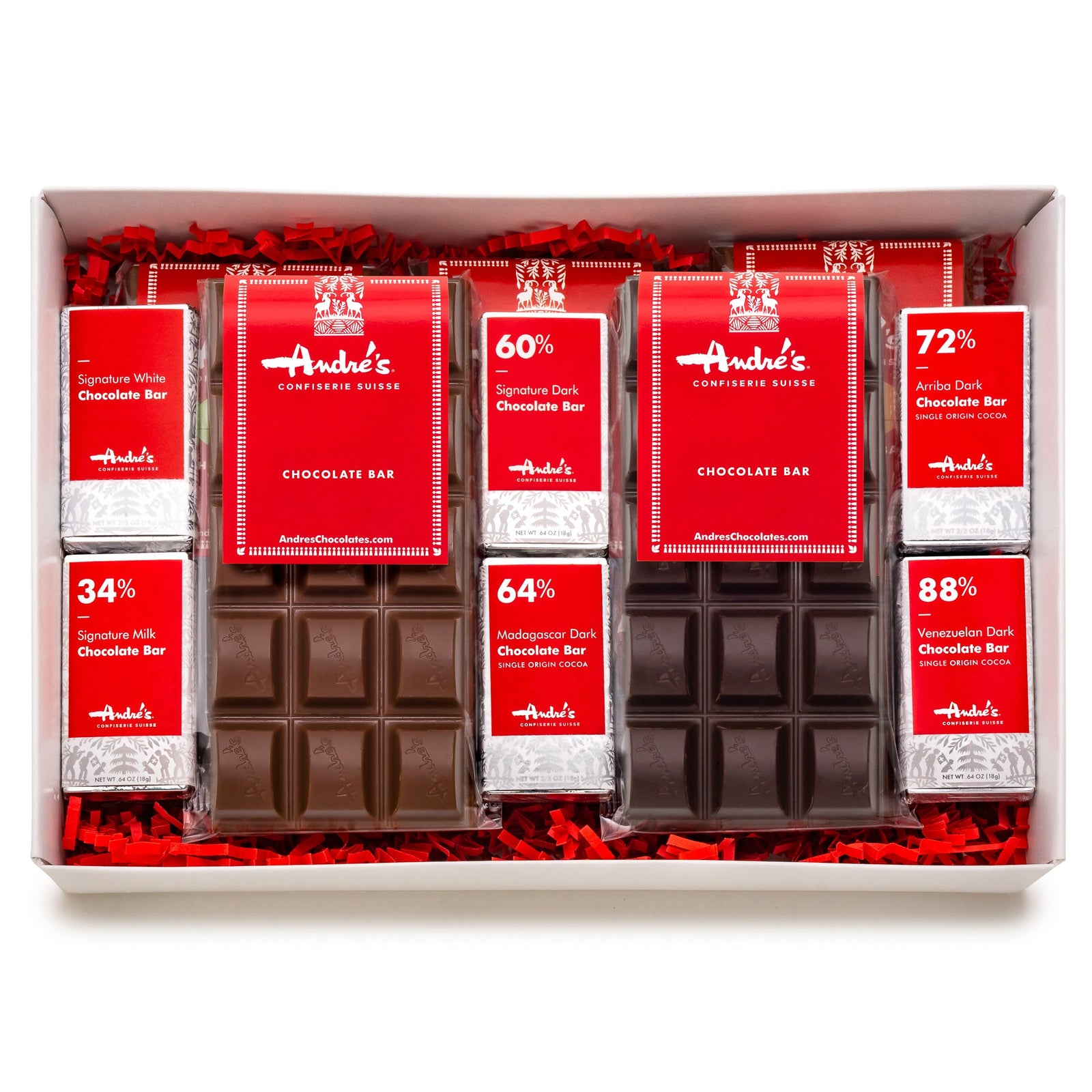 A white box padded with red crinkle paper that contains several large and small chocolate bars with red product labels.