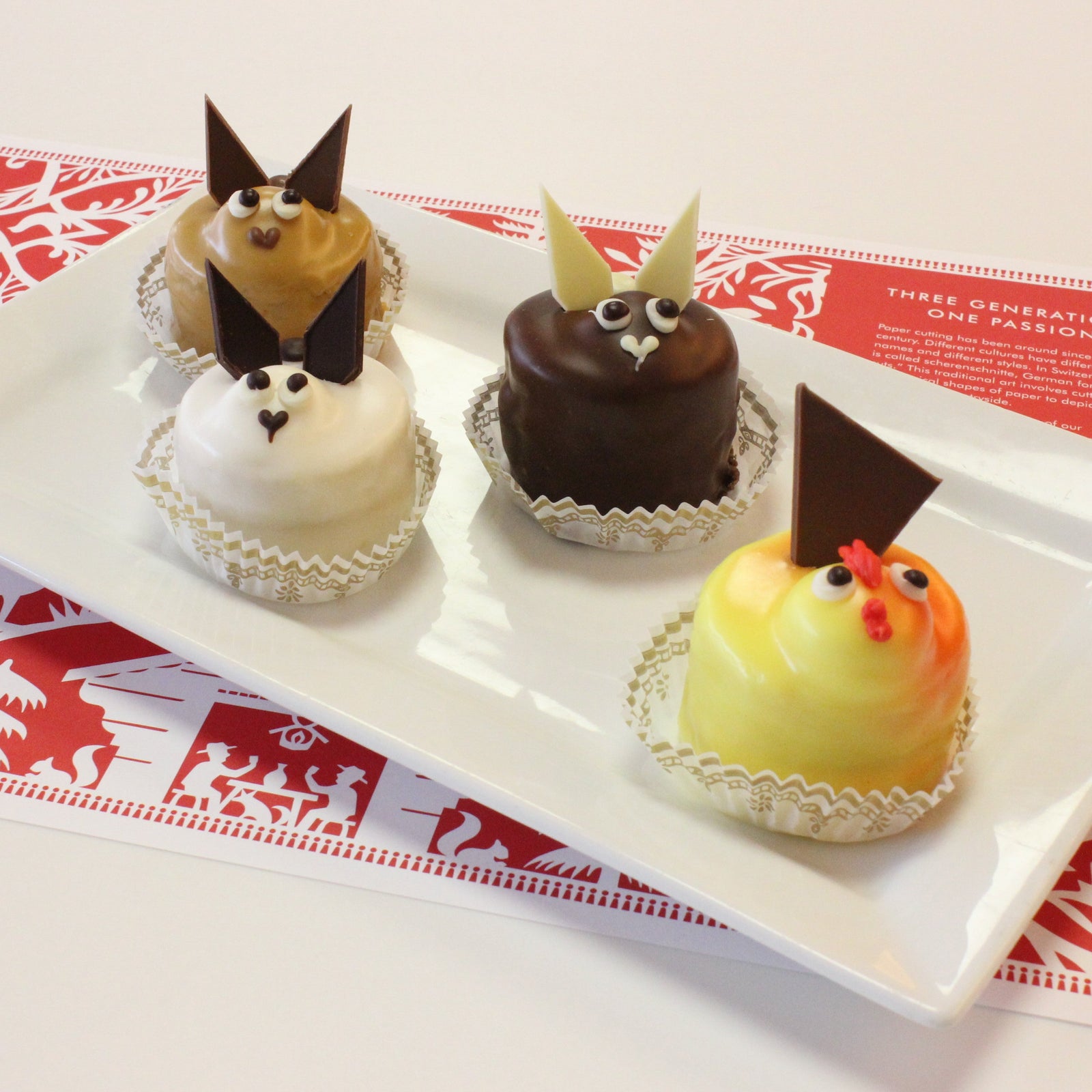 3 bunny pastries and a chick pastry on a white plate.