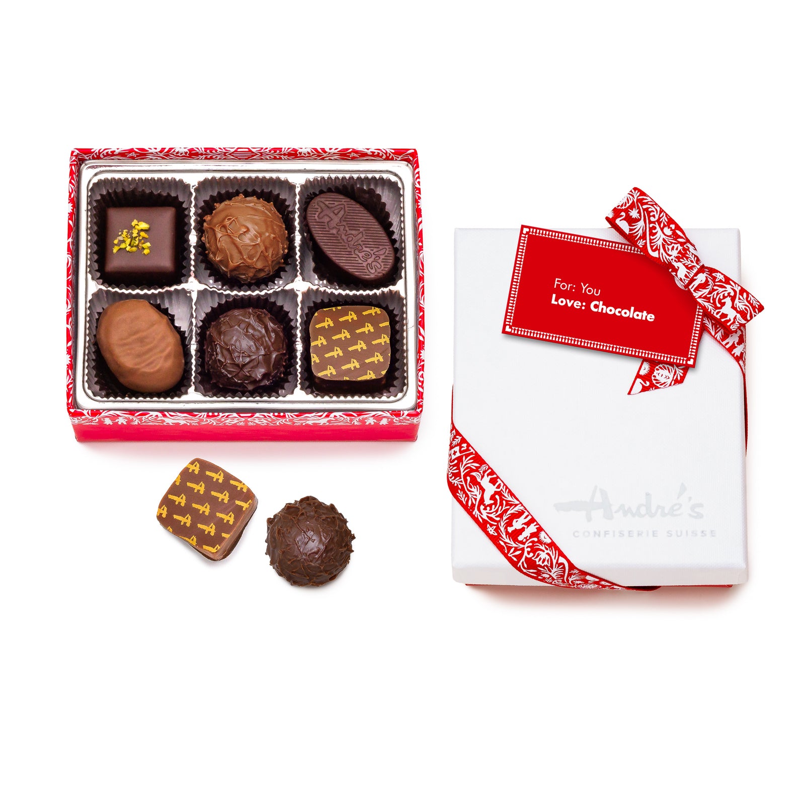 A red box base filled with 40 assorted chocolate candies next to its white Andre's logo lid and red Swiss patterned bow. 3 loose candies beside it.