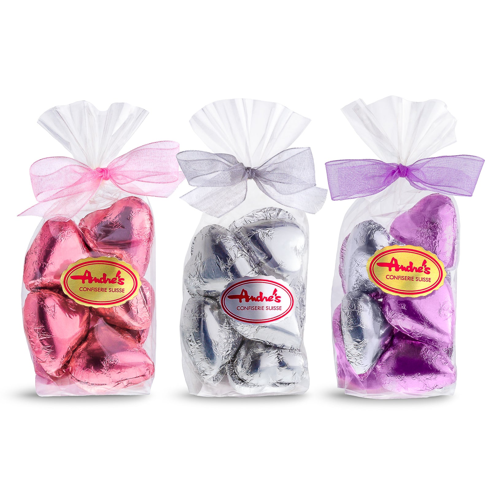 3 clear bags, each filled with foil covered hearts and tied with a sheer ribbon. Each features an Andre's logo sticker on the front.