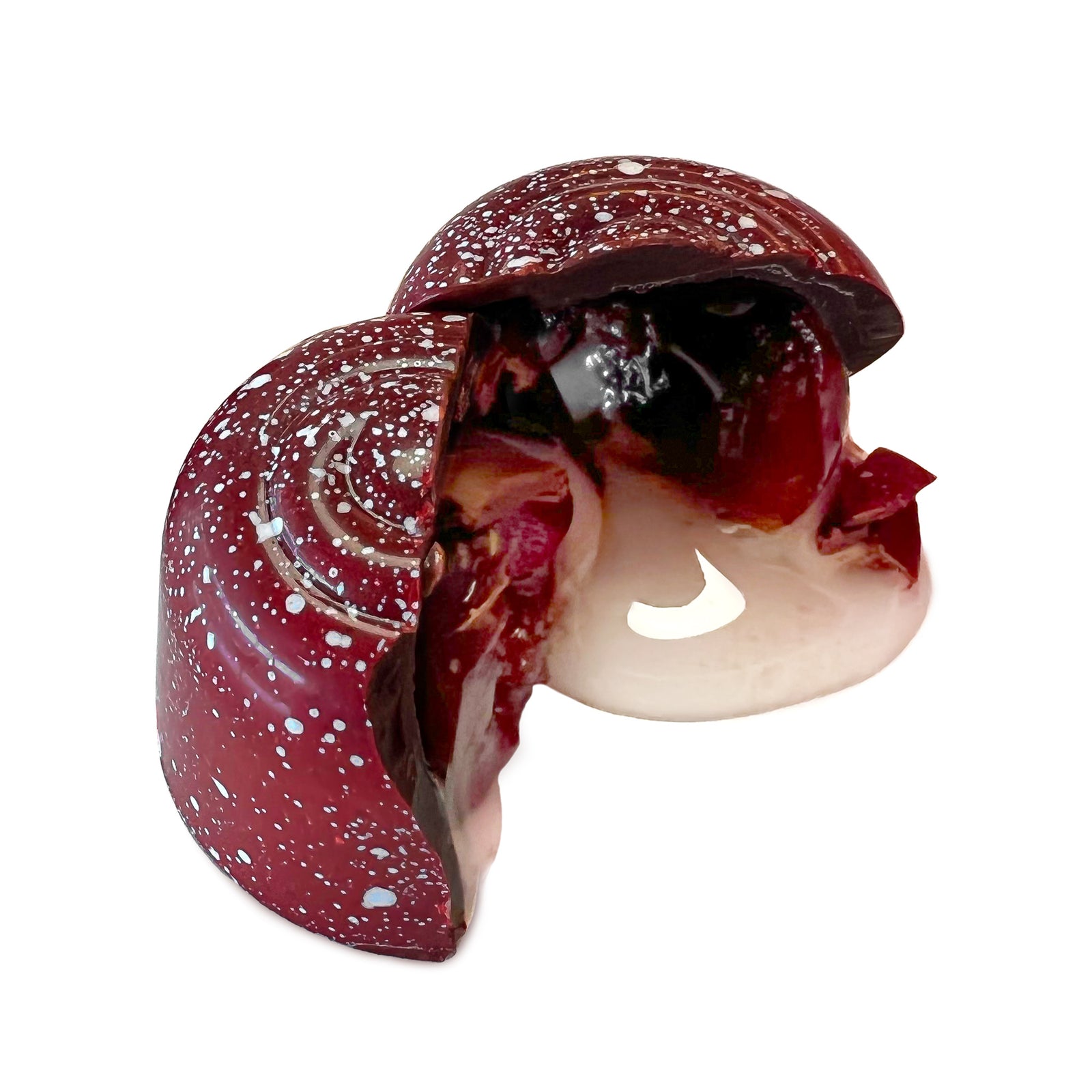 Box with red product label next to an open box with 6 white speckled maroon candies and 3 loose candies beside.