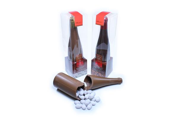Clear box with champagne split bottle made of milk chocolate with red product label.
