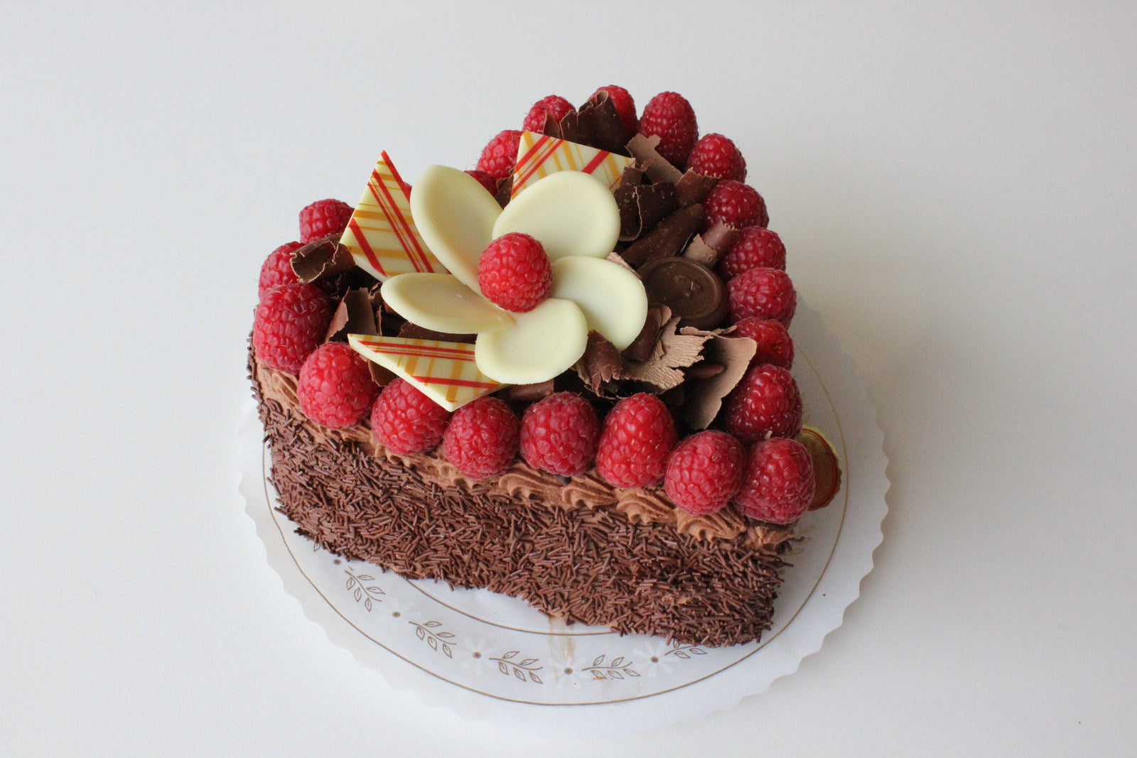 Heart shaped torte with chocolate ganache top and chocolate heart decor. 