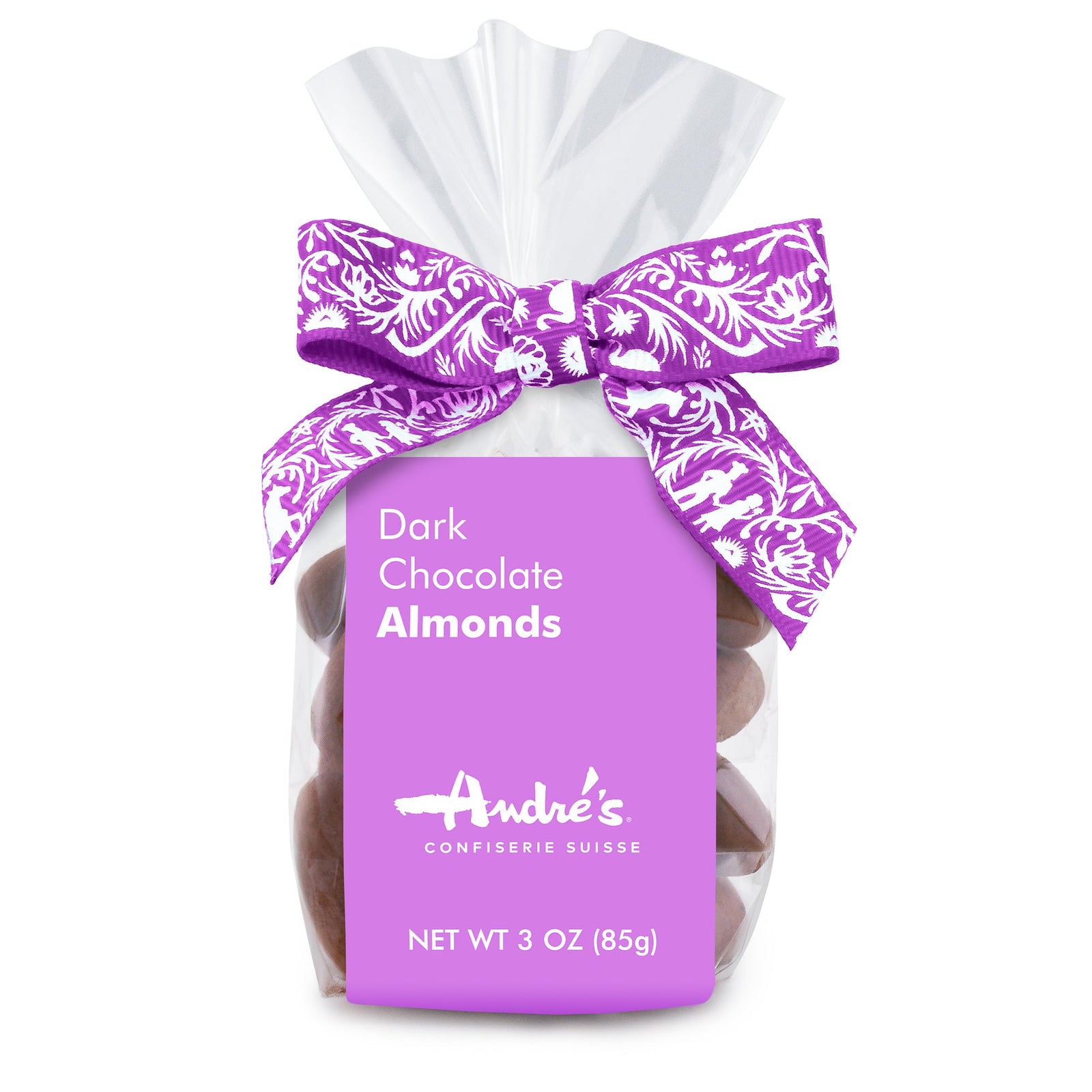 Clear bag containing cocoa powder coated chocolate almonds with a lavender product label and Swiss print bow.