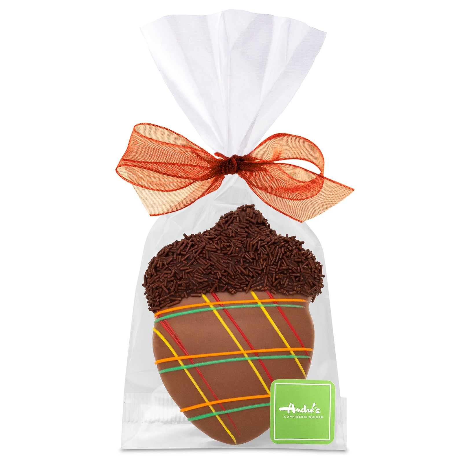 An acorn-shaped cookie, covered in milk chocolate and decorated with fall colored icing and chocolate sprinkles, in a clear bag with a orange bow and green Andre's logo sticker.