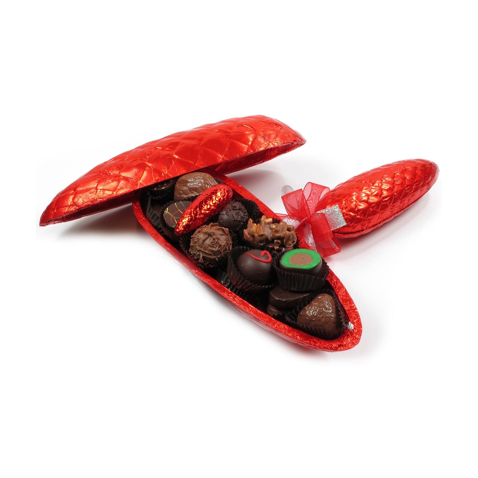 Assorted chocolate candies inside the base of a red foil covered pinecone shell next to the top shell and another whole pinecone closed and tied with a red ribbon.